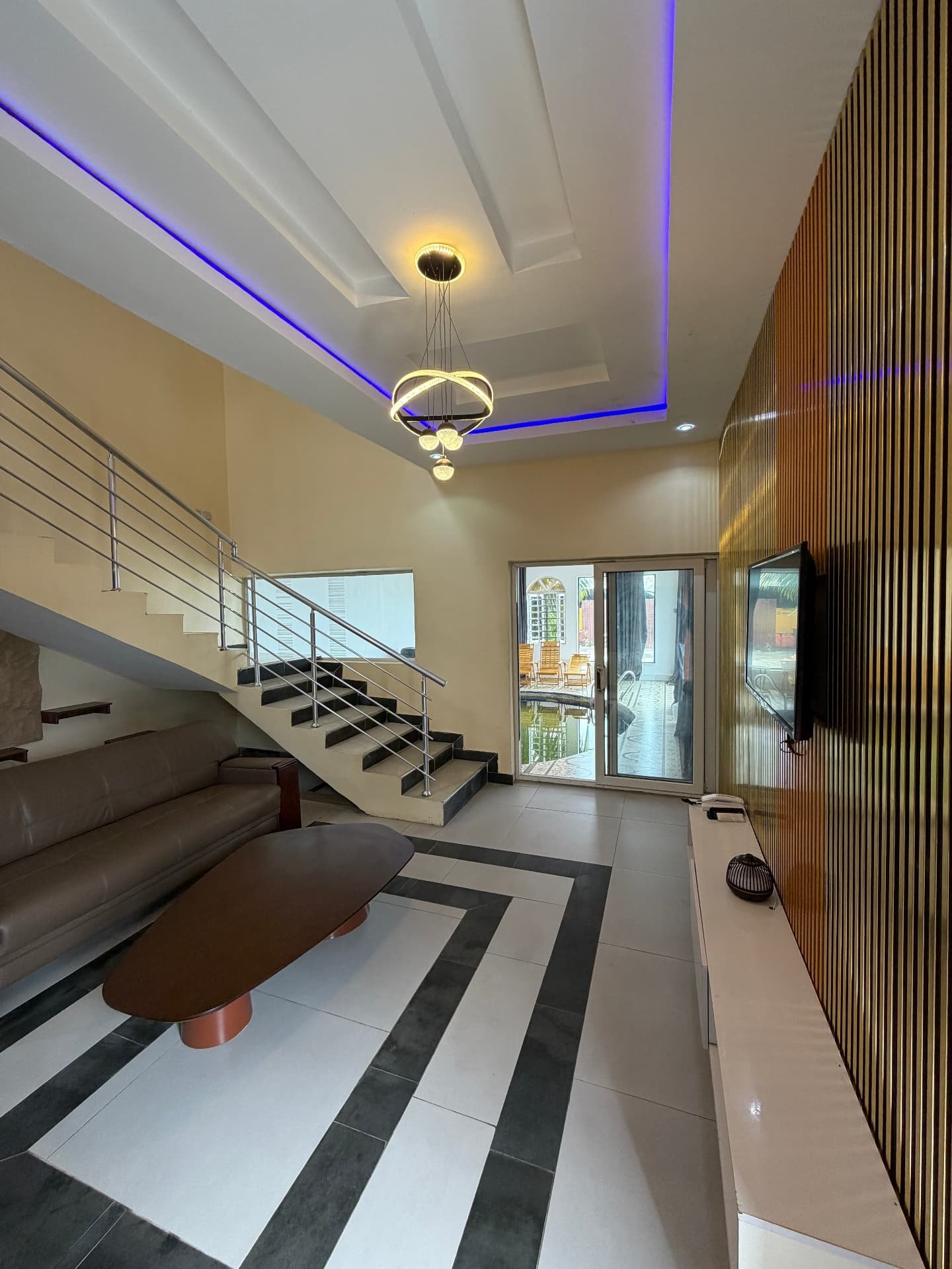 Seating area and large wall-mounted TV in the 2 Bed pool apartment